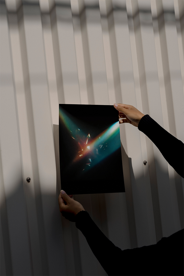 A HUEDRA collector holding artwork
